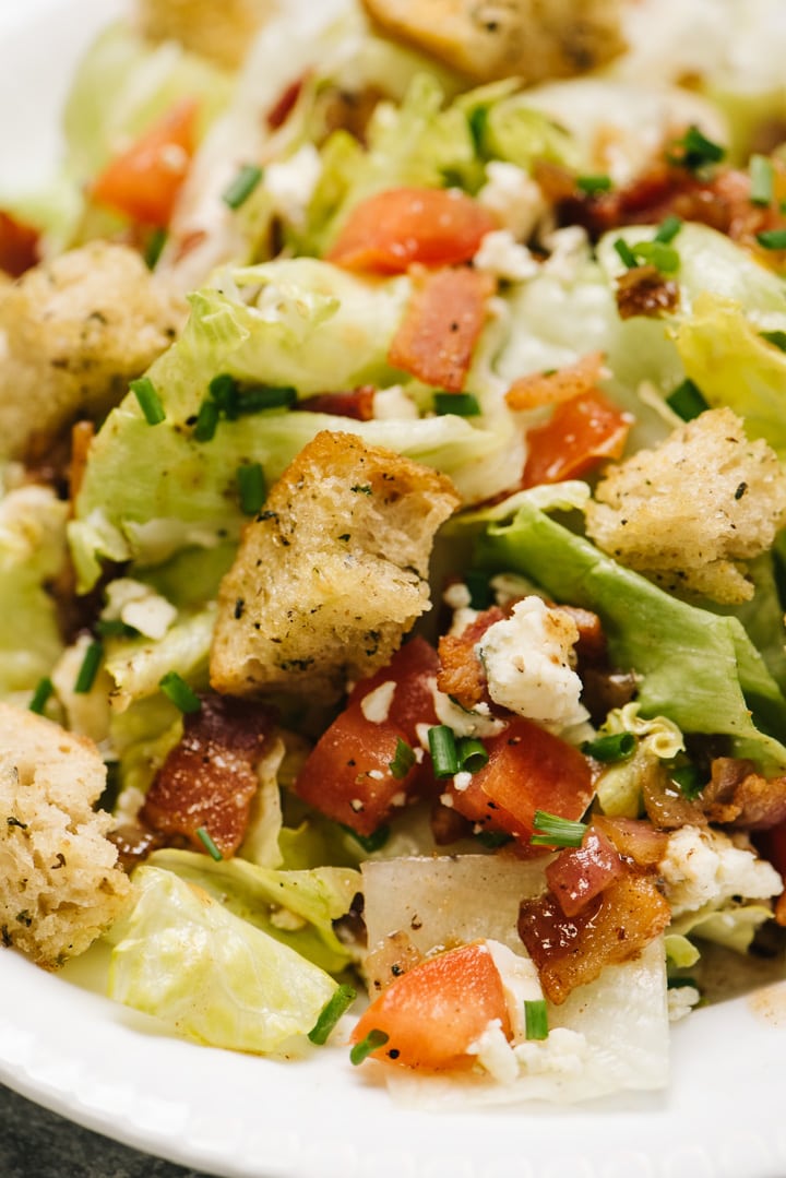 Close up of chopped wedge salad with all of the toppings. 
