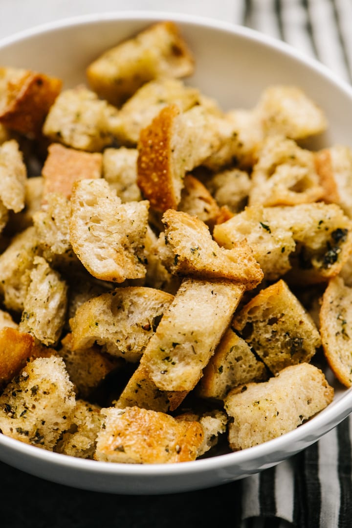 Bowl of crunchy homemade herb croutons.