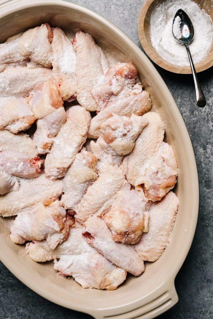 Raw chicken wings sprinkled with salt and baking powder. 