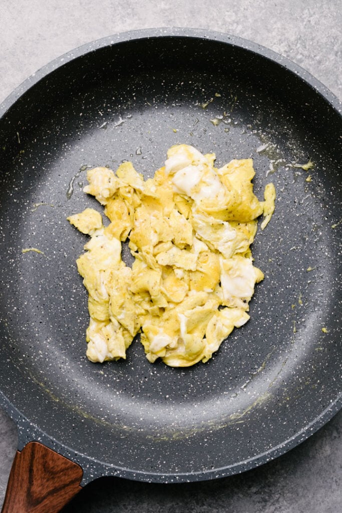 Scrambled eggs in a large non-stick sillet.