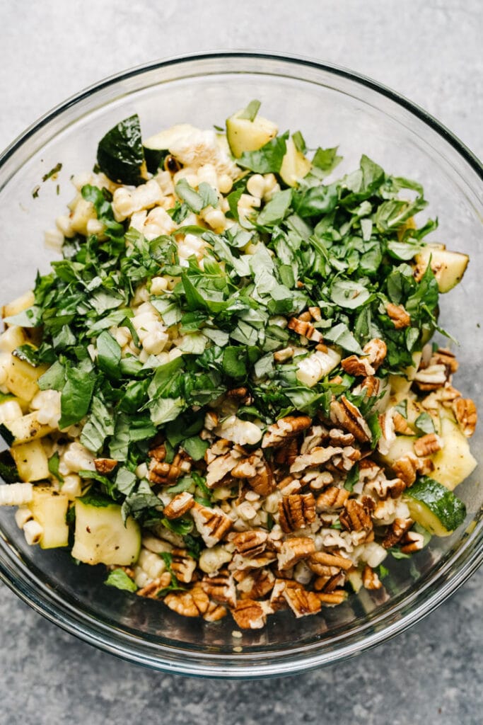 Grilled zucchini salad ingredients in a bowl.