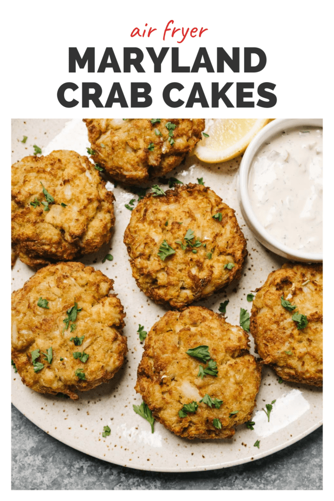 Crab cakes on a plate with tartar sauce on the side, a top banner reads air fryer Maryland crab cakes.