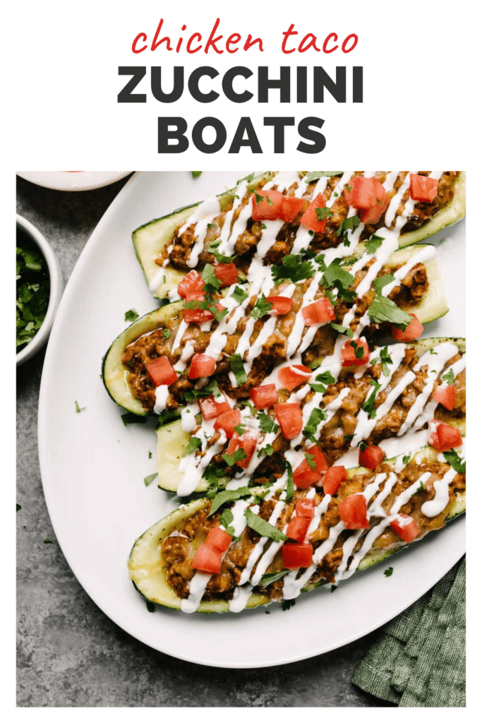 Stuffed zucchini boats on a plate with salsa and sour cream, and a top banner that reads chicken taco zucchini boats.