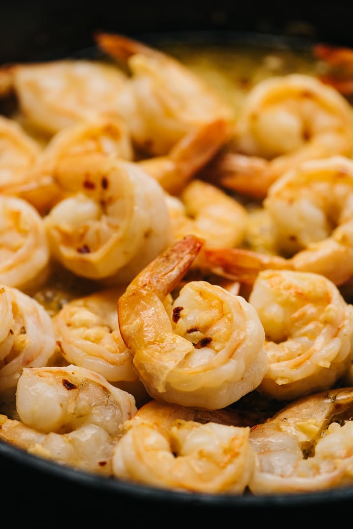 Shrimp cooked with butter and garlic in a skillet.