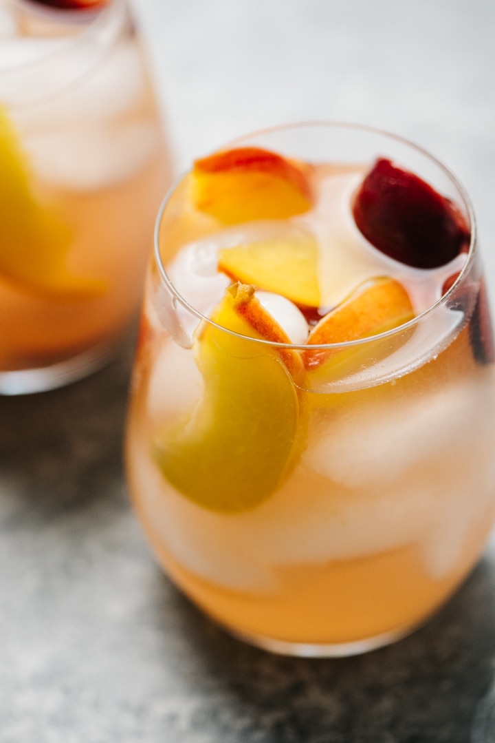Wine glasses filled with peach sangria. 