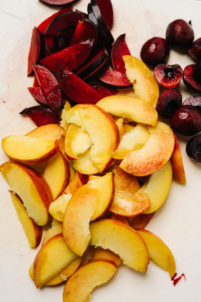 Sliced peaches, plums, and cherries. 