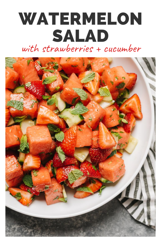 Watermelon salad in a bowl with a top banner that reads watermelon salad with strawberries and cucumbers.