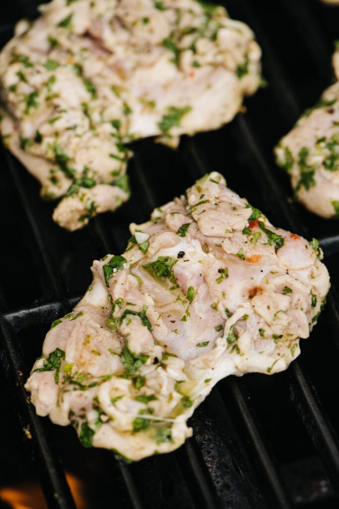 Cilantro lime chicken thighs on a grill.