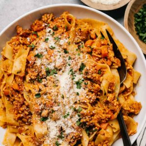 A plate of chicken bolognese pasta.