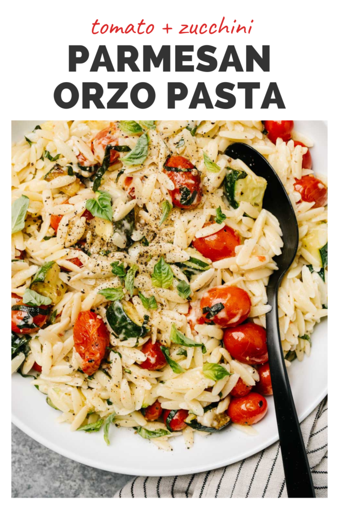 Orzo pasta in a bowl with a top banner that reads tomato and zucchini parmesan orzo pasta.