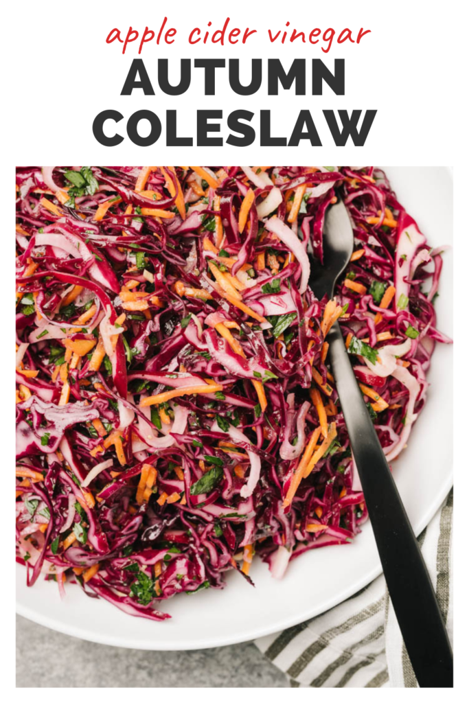 Coleslaw on a white plate and a top banner that reads apple cider vinegar autumn coleslaw.