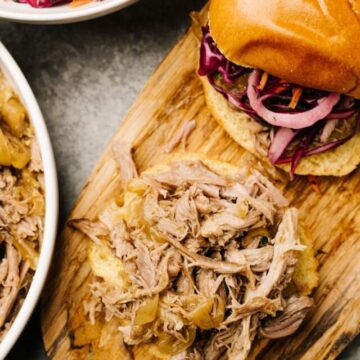 Pulled pork sandwiches on buns with onions and coleslaw.