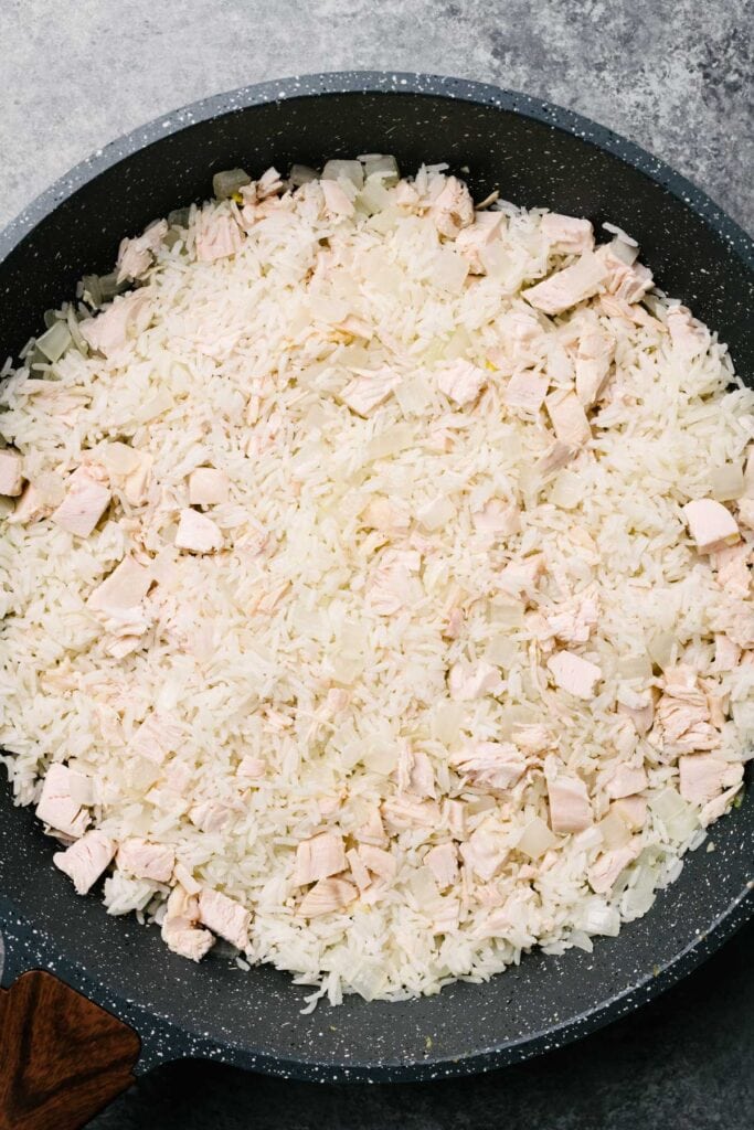 Leftover turkey and cold rice frying in a skillet.