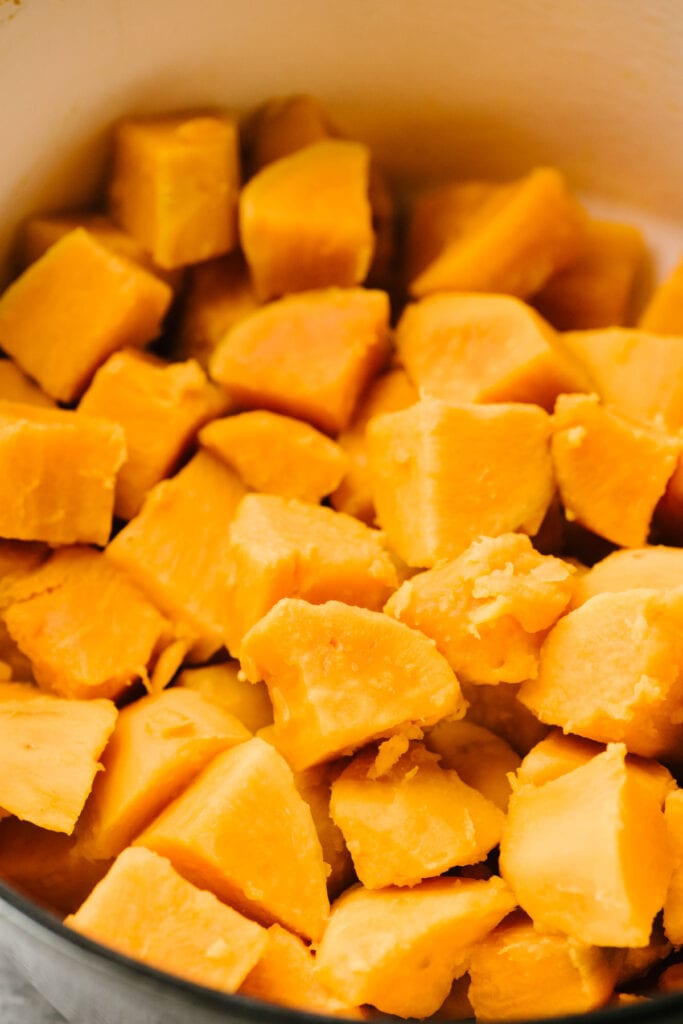 Cubed sweet potatoes in a mixing bowl. 