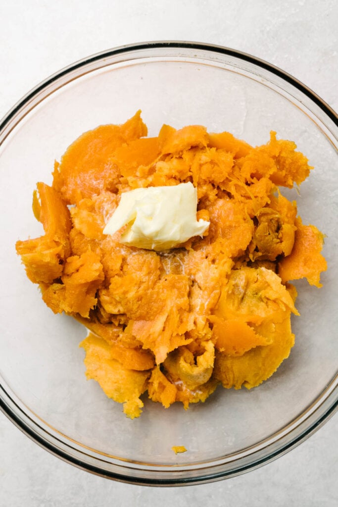 Sweet potato flesh mash in a bowl with butter. 