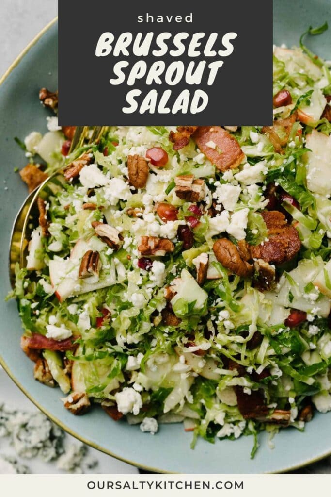 Brussels sprouts salad with bacon, apples, pomegranate seeds, pecans, and blue cheese in a blue salad bowl with gold serving utensils; title bar at the top reads "shaved Brussels sprout salad".