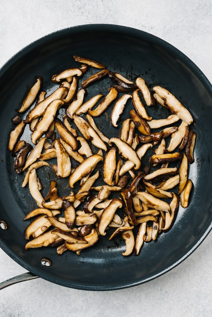 Stir fried shiitake mushrooms in a large skillet.