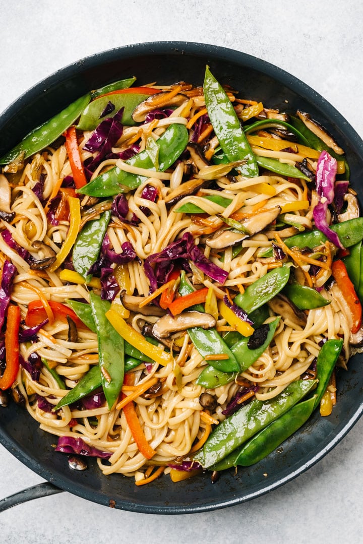 Stir fry noodles with mushrooms and vegetables in a large skillet.