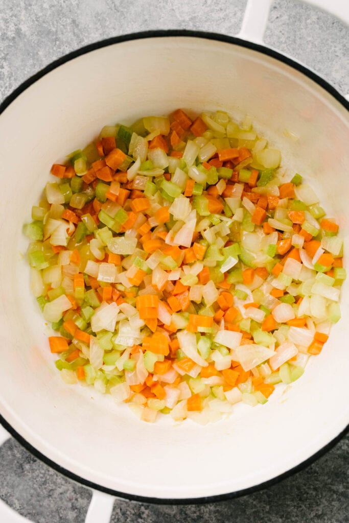 Diced onions, carrots, and celery sautéed in butter in a white dutch oven.