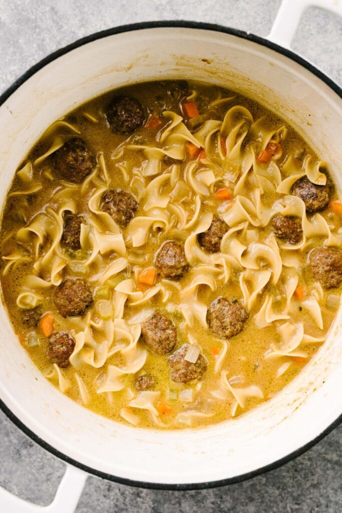 Swedish meatball soup in a white dutch oven.