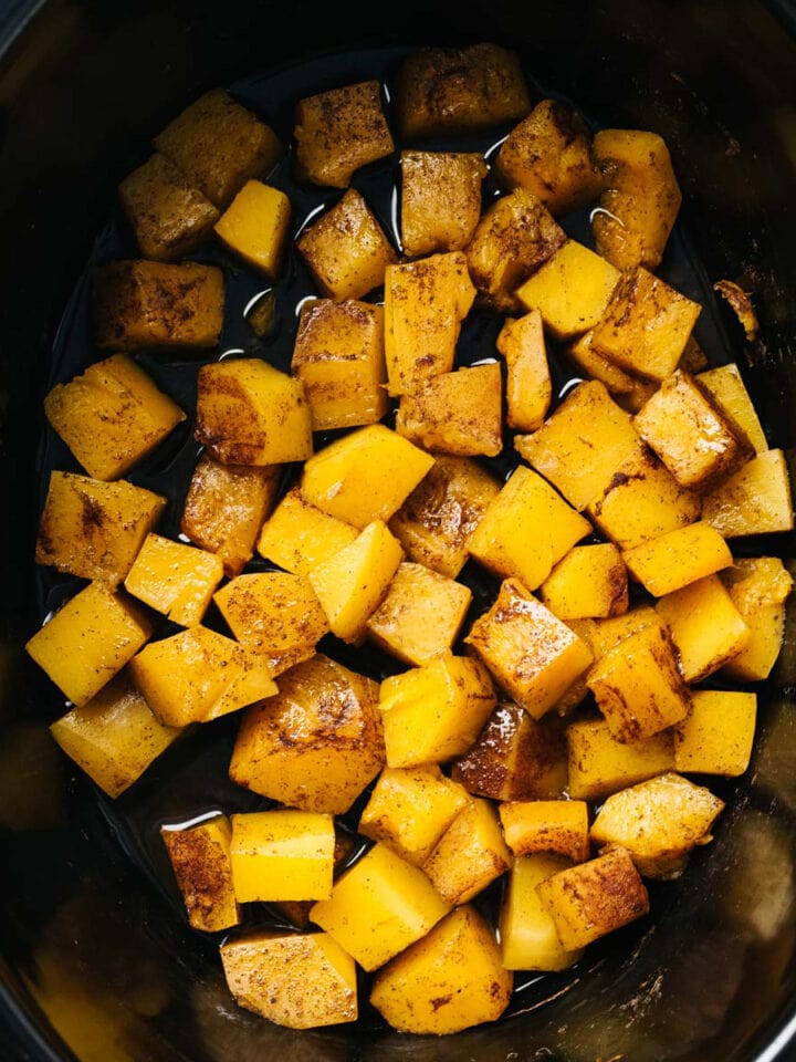 Diced butternut squash with brown sugar, cinnamon, and nutmeg slow cooked in a crockpot.