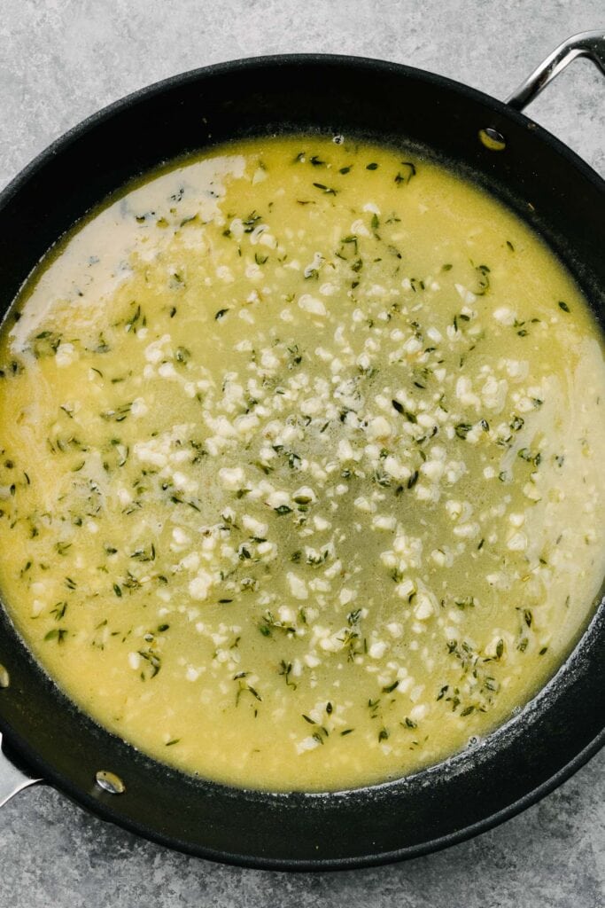 Garlic butter pan sauce for chicken in a skillet.