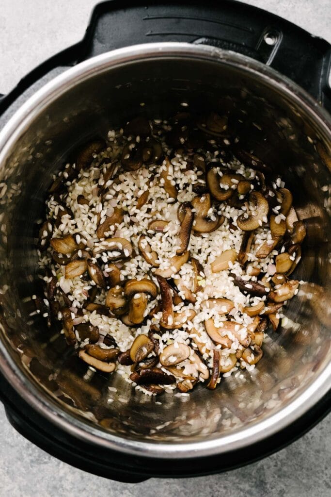 Sautéed mushrooms with toasted arborio rice in and Instant Pot.