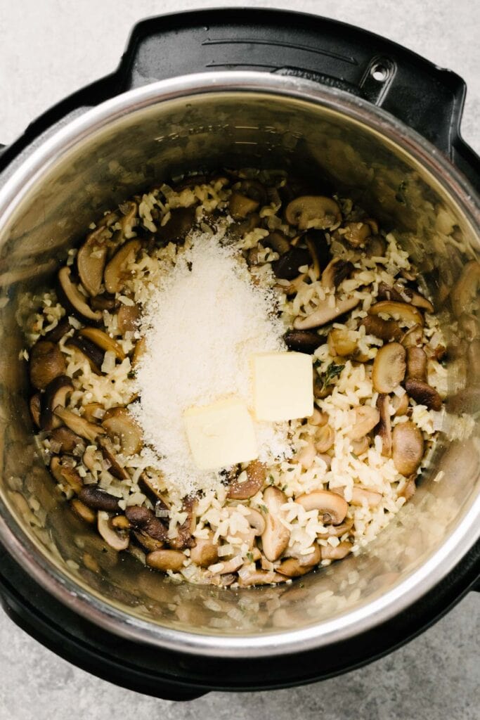Butter and parmesan cheese added to Instant Pot mushroom risotto.