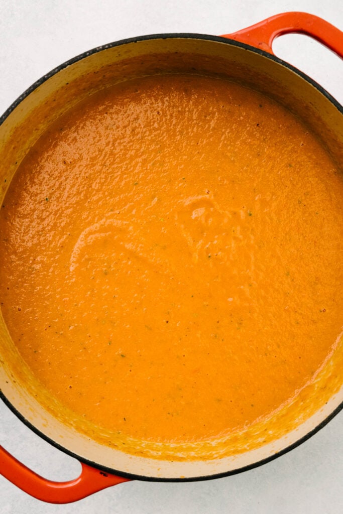 Creamy tomato basil soup made with fresh tomatoes in a dutch oven.