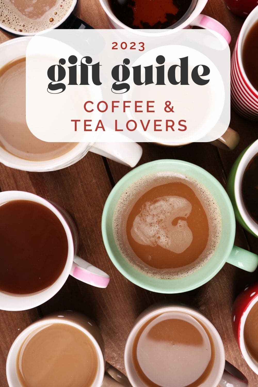 A collection of colored mugs on a wood background filled with coffee and tea; text overlay reads "2023 gift guide for coffee and tea lovers".