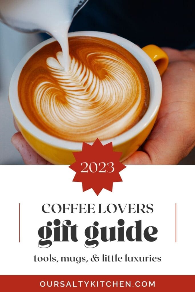 Side view, a hand holding a cappuccino cup with another hand pouring foam on top; text box at the bottom reads "2023 Coffee lovers gift guide".