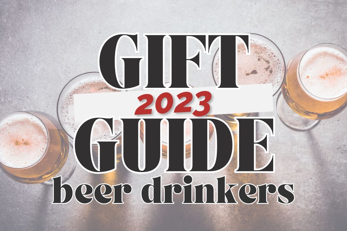 Overhead view - various shaped beer glasses filled with beer on a concrete background; text overlay reads "2023 gift guide for beer drinkers".