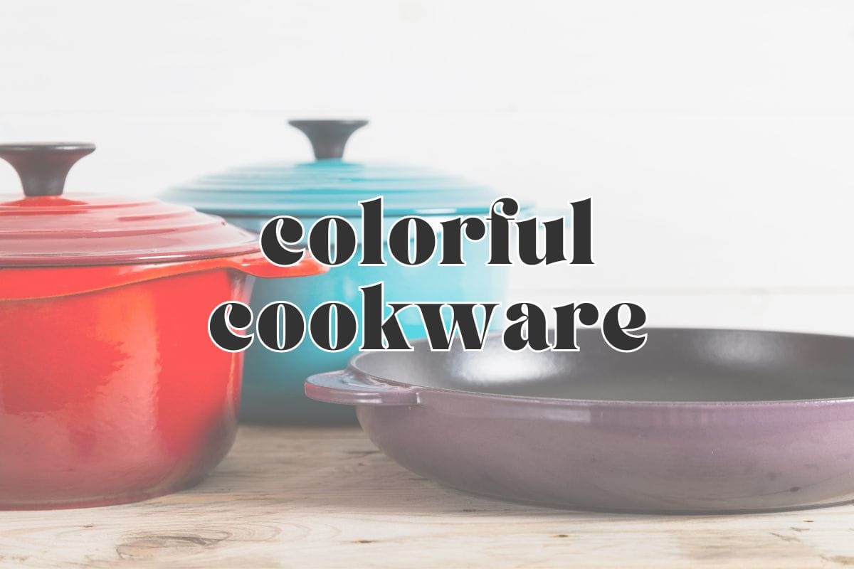 Side view, a red dutch oven, blue dutch oven, and purple skillet on a wood counter; text overlay reads "colorful cookware".