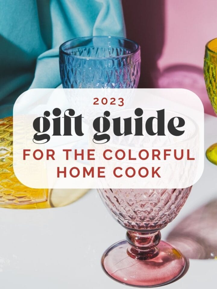 Various colored vintage glasses agains a pink and blue background; text overlay reads "2023 gift guide for the colorful home cook".