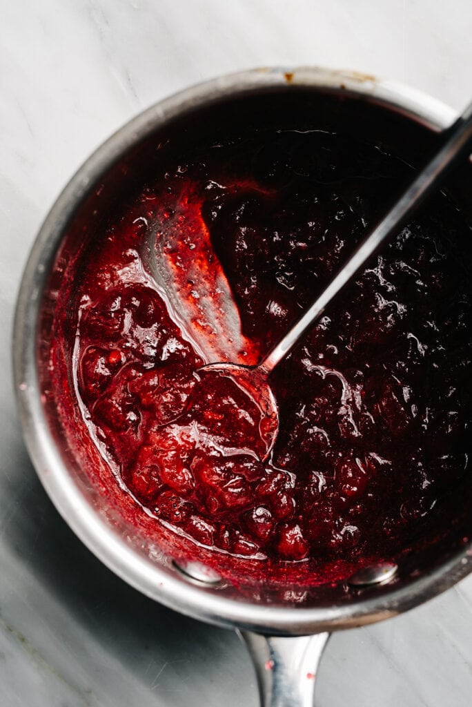 Fresh cranberries simmered with water and sugar in a small saucepan until the cranberries burst and thicken.