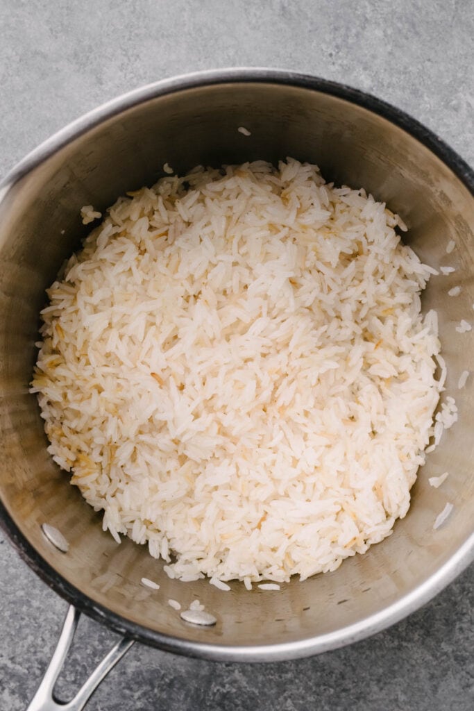 Cooked white rice in a saucepan.