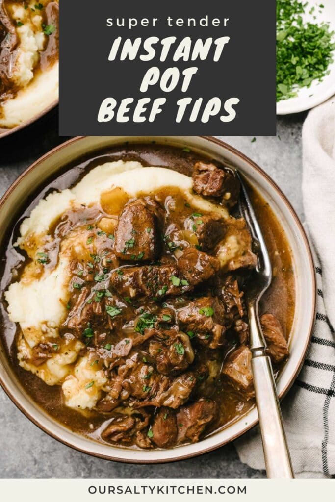 A fork tucked into Instant pot beef tips over mashed potatoes in a low serving bowl on a concrete background, surrounded by a striped linen napkin and small bowl of finely chopped parsley; title bar at the top reads "super tender Instant Pot beef tips".